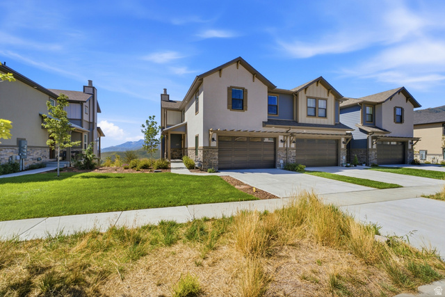 6039 North Westridge Road Heber City, UT 84032 - Photo 61 of 71 Stucco exterior with stone accents, attached two-car garage, covered entry, and landscaped front yard