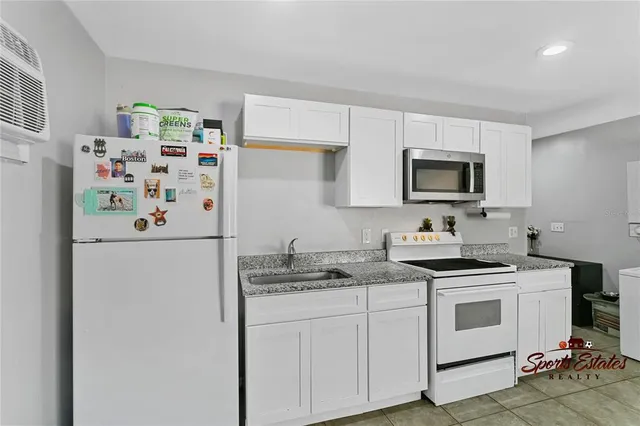 a kitchen with stainless steel appliances a refrigerator sink and microwave