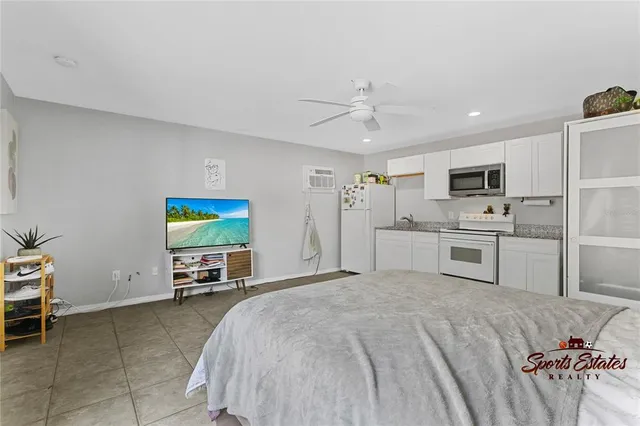 a bedroom with a bed and a television