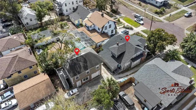 an aerial view of a house with a yard and potted plants