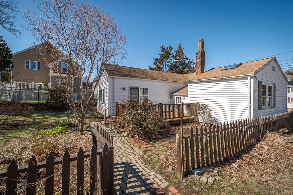 3 Davis St Extension Gloucester, MA 01930 - Photo 2 of 29 a view of a house with wooden fence next to a yard