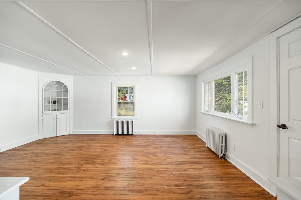 3 Davis St Extension Gloucester, MA 01930 - Photo 6 of 29 a view of empty room with window and wooden floor