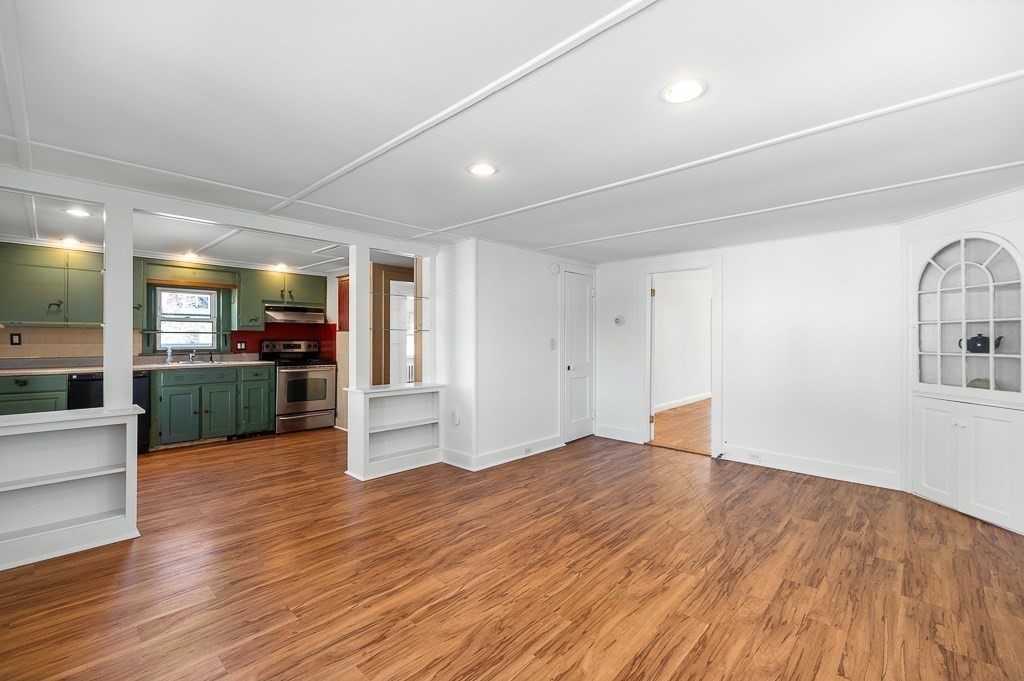 3 Davis St Extension Gloucester, MA 01930 - Photo 8 of 29 a view of a kitchen with wooden floor and a sink