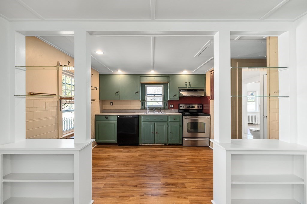 3 Davis St Extension Gloucester, MA 01930 - Photo 9 of 29 a kitchen with kitchen island a counter top space a sink stainless steel appliances and cabinets