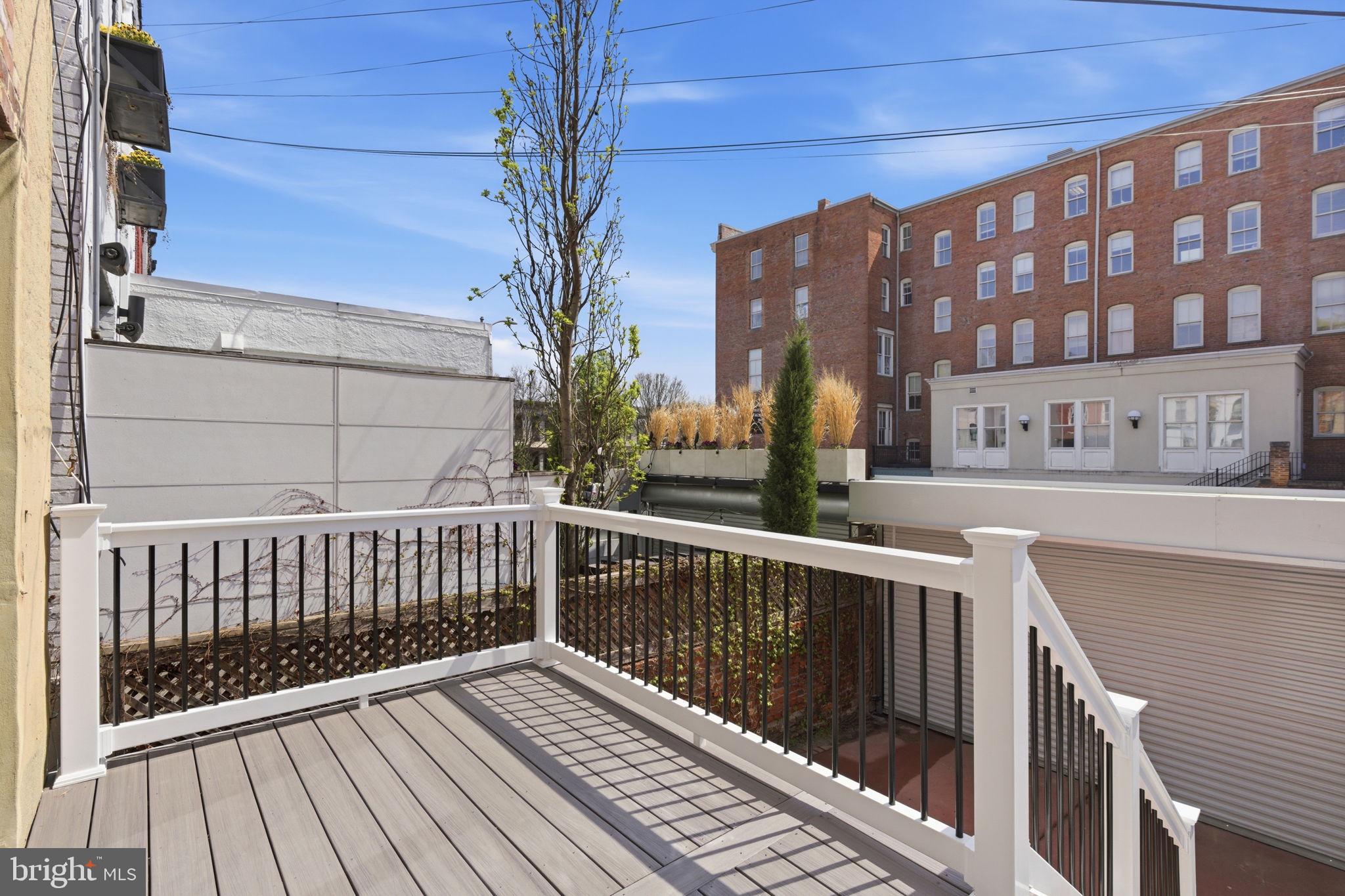 1210 T Street Northwest Washington, DC 20009 - Photo 17 of 41 a view of a balcony with wooden floor and fence