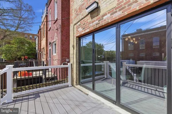a view of a balcony with floor to ceiling windows with wooden floor