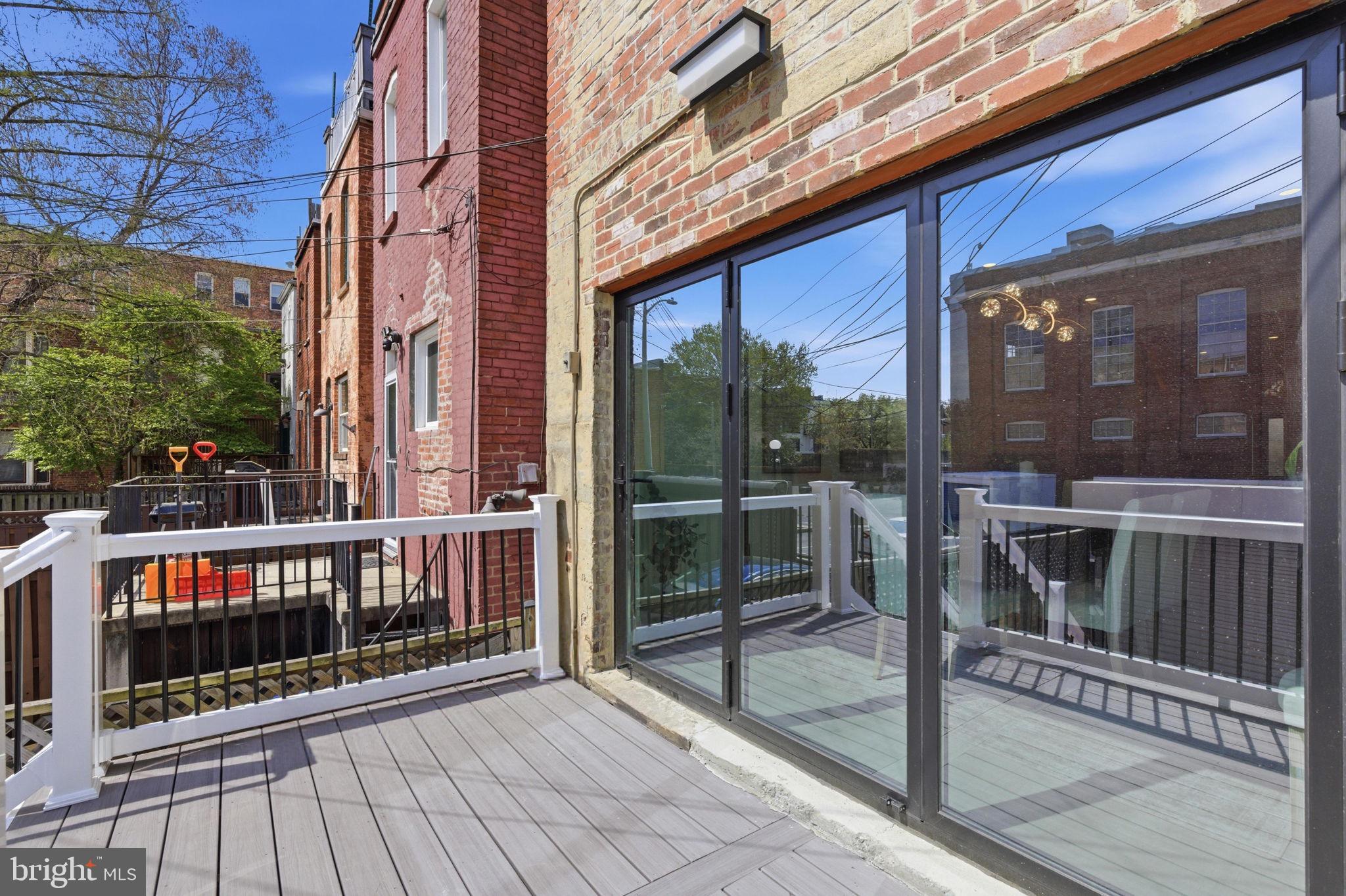 1210 T Street Northwest Washington, DC 20009 - Photo 18 of 41 a view of a balcony with floor to ceiling windows with wooden floor