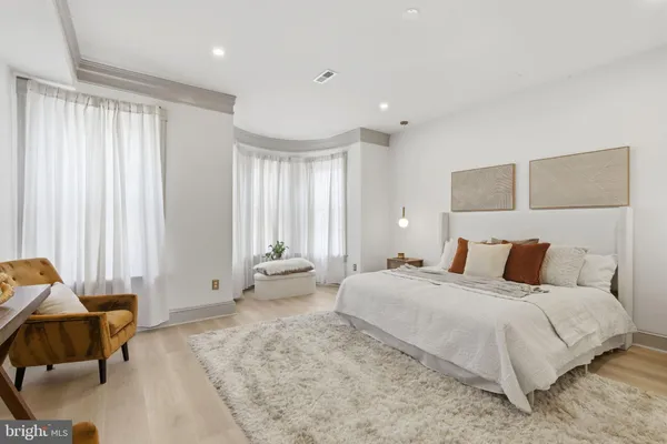 a bedroom with a bed and a couch