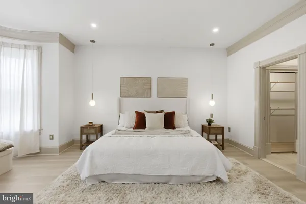 a bedroom with a bed and a couch