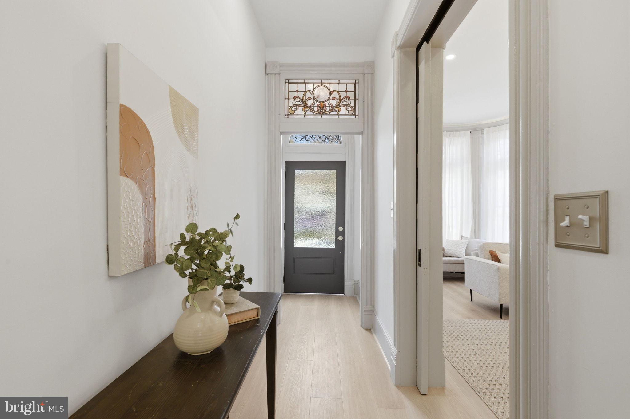 1210 T Street Northwest Washington, DC 20009 - Photo 2 of 41 a view of a hallway with wooden floor and a potted plant