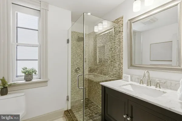 a bathroom with a granite countertop sink mirror and double