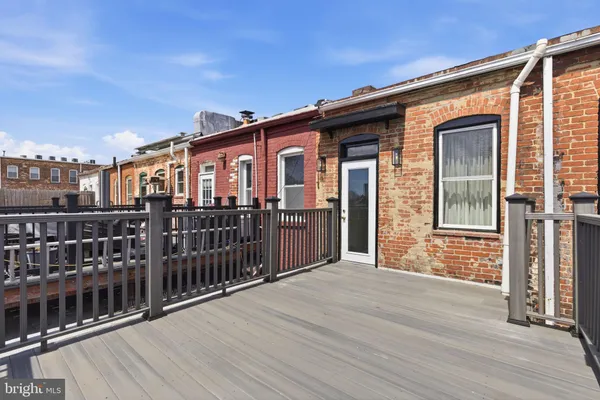 a front view of a house with wooden deck