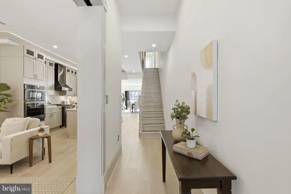 a hallway with dining table and chairs
