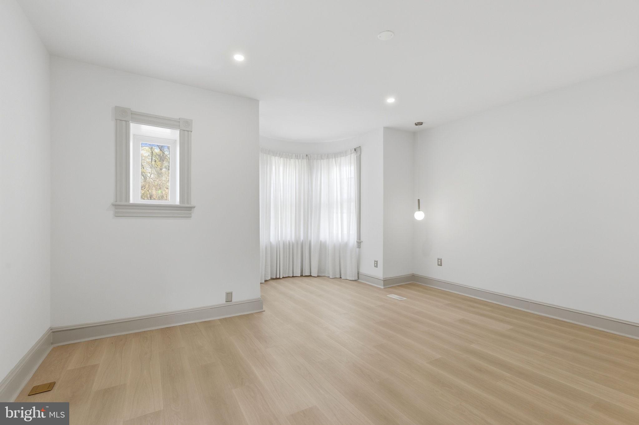 1210 T Street Northwest Washington, DC 20009 - Photo 32 of 41 an empty room with wooden floor and windows