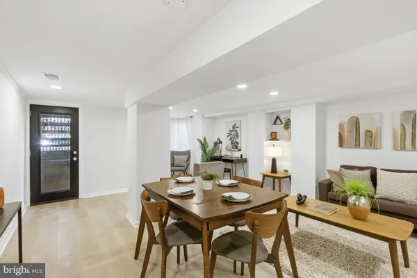 a view of a dining room with a table and chairs