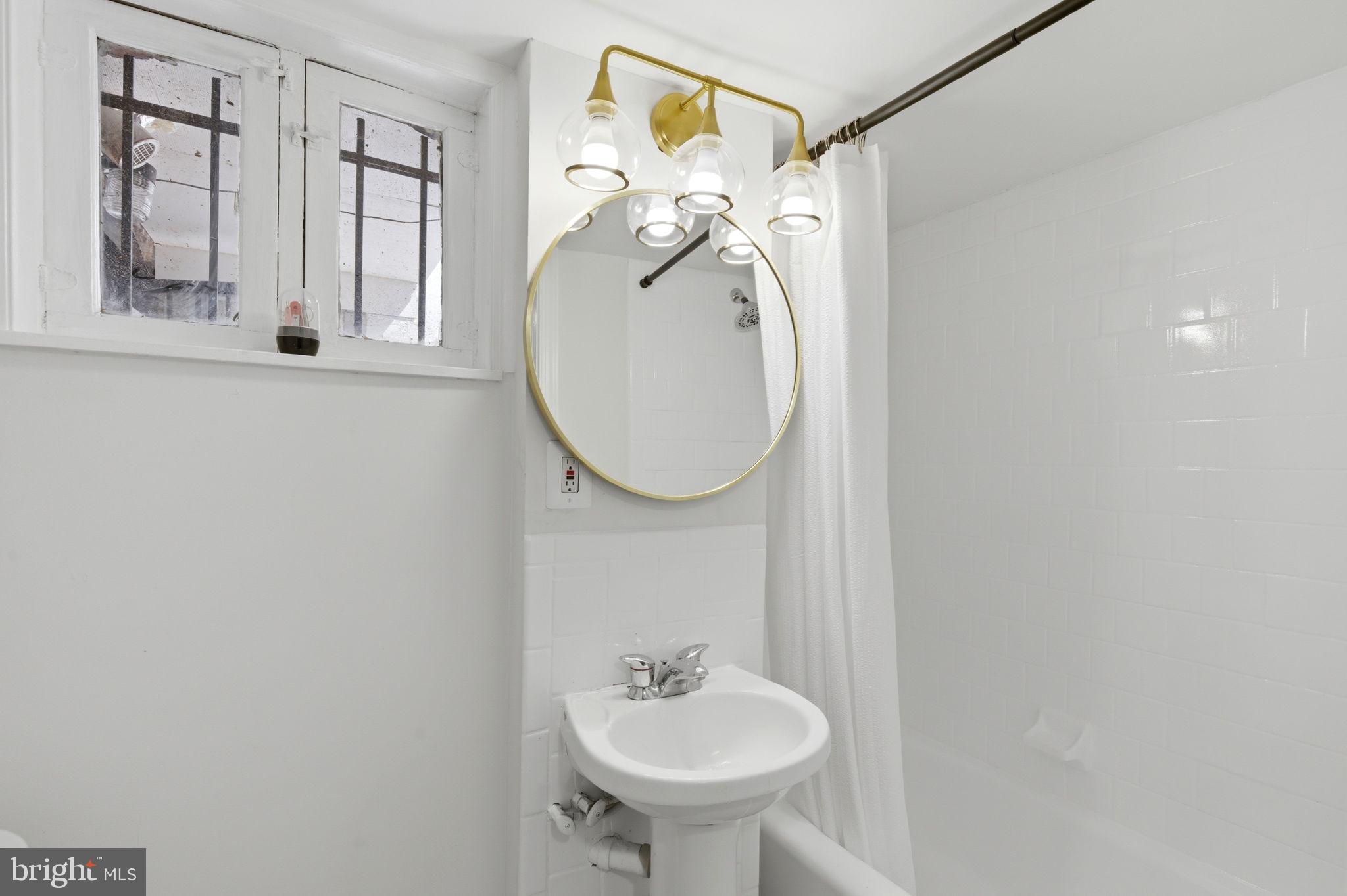 1210 T Street Northwest Washington, DC 20009 - Photo 37 of 41 a bathroom with a sink and a mirror