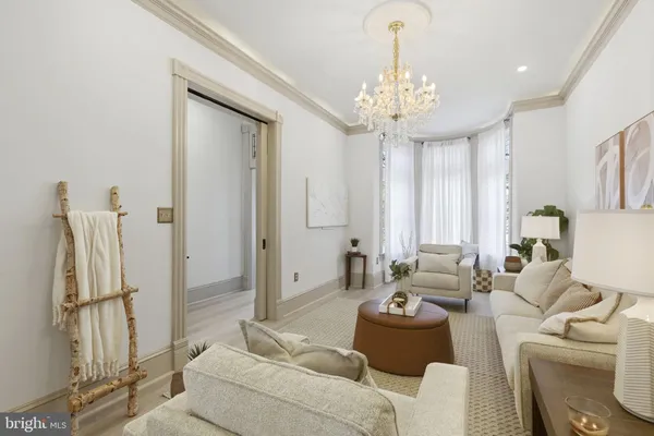 a living room with furniture and a chandelier
