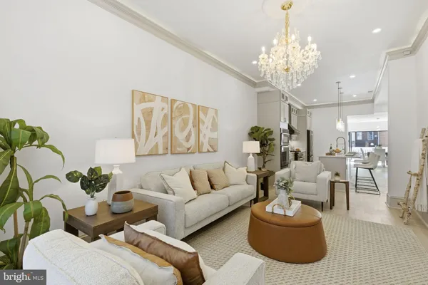 a living room with furniture and a chandelier