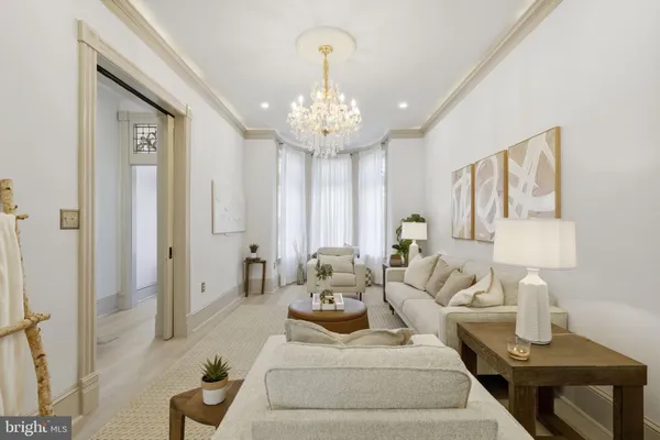 a living room with furniture and a chandelier