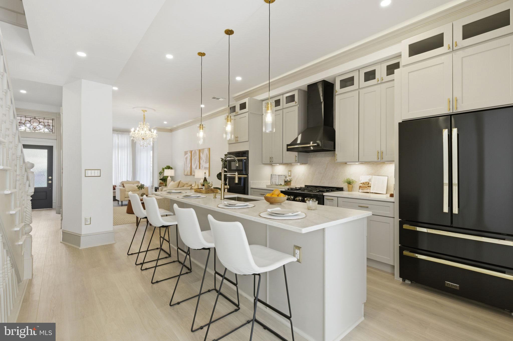 1210 T Street Northwest Washington, DC 20009 - Photo 7 of 41 a kitchen with stainless steel appliances granite countertop a refrigerator a stove a sink a dining table and chairs with wooden floor