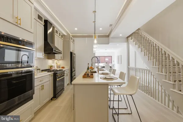 a kitchen with sink cabinets and stove top oven