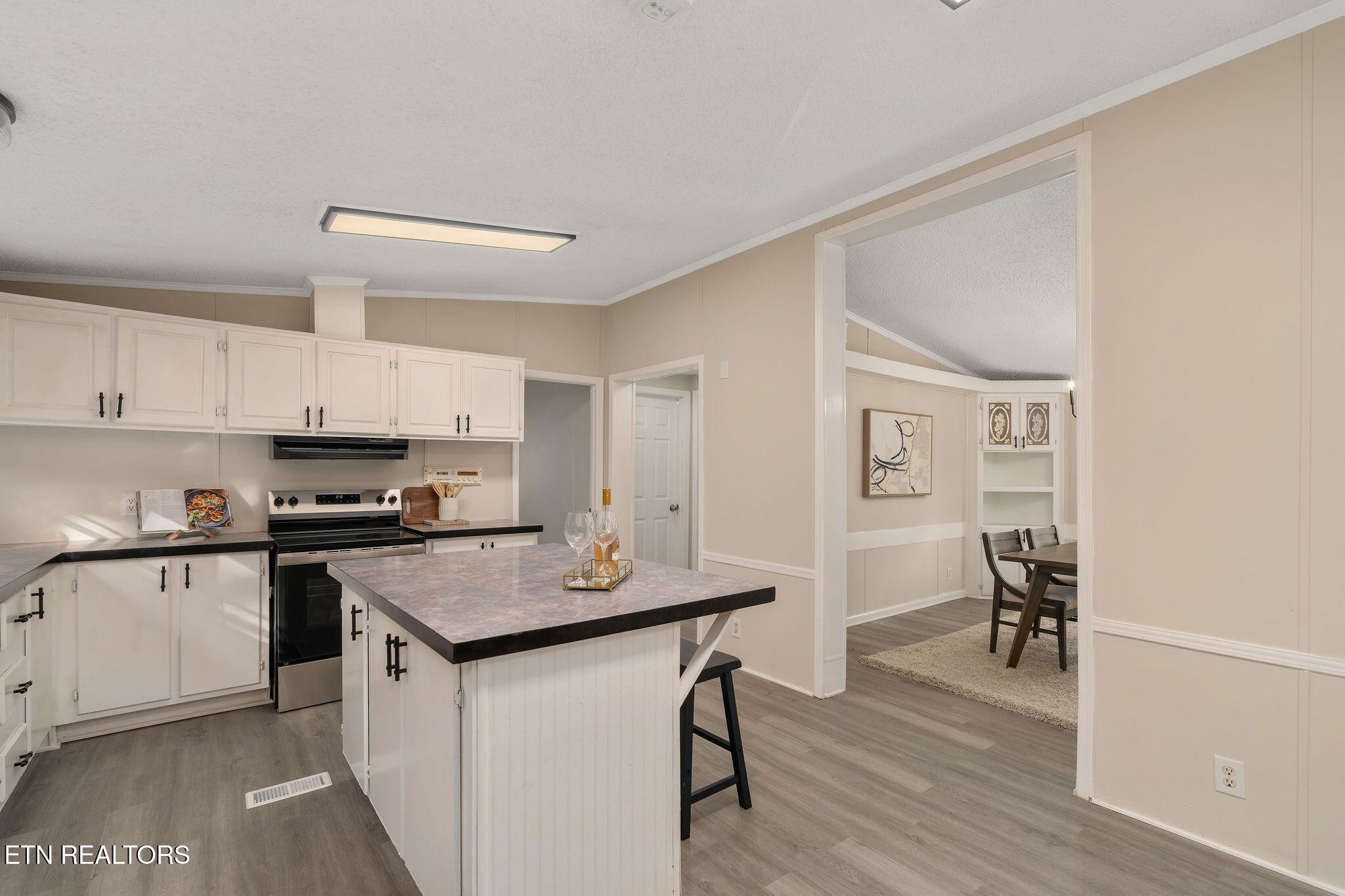 3315 Chuckey Highway Limestone, TN 37681 - Photo 14 of 40 a kitchen with kitchen island a stove a table and chairs in it