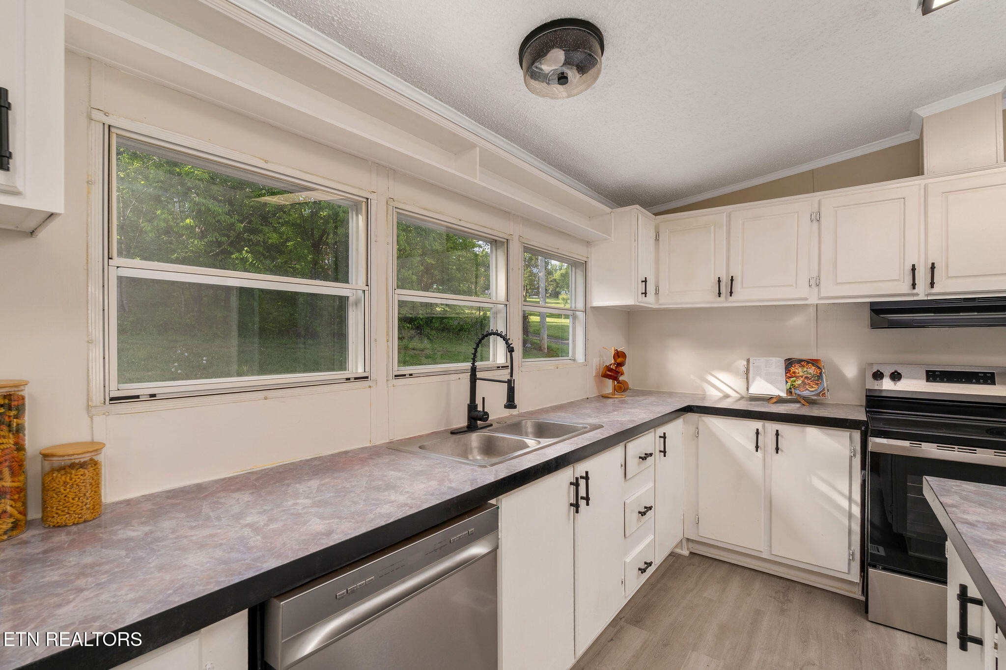 3315 Chuckey Highway Limestone, TN 37681 - Photo 15 of 40 a kitchen with granite countertop a sink and white cabinets