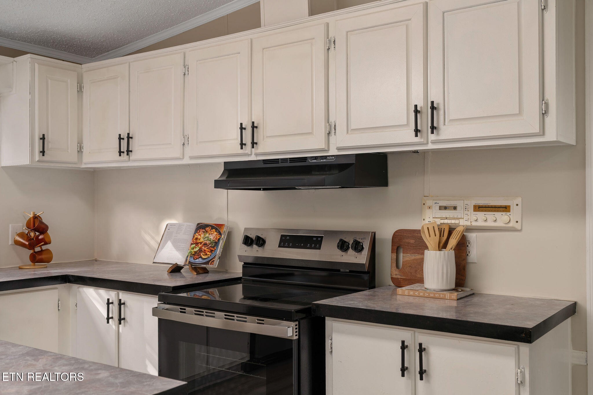 3315 Chuckey Highway Limestone, TN 37681 - Photo 18 of 40 a kitchen with stainless steel appliances granite countertop a sink dishwasher a stove and white cabinets