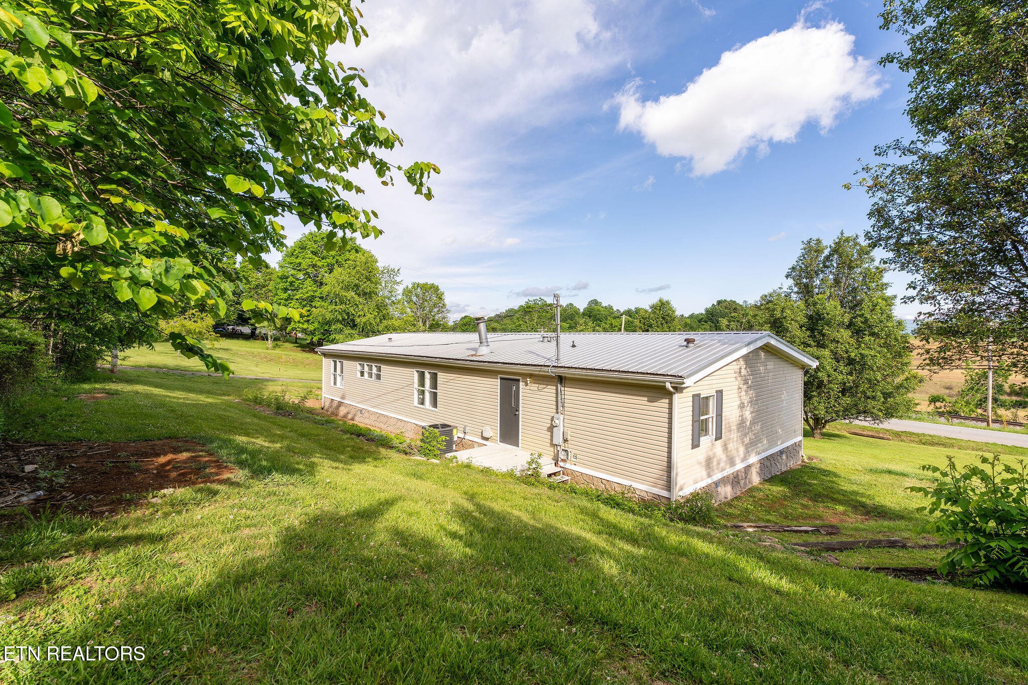 3315 Chuckey Highway Limestone, TN 37681 - Photo 37 of 40 a view of a house with a big yard and large trees