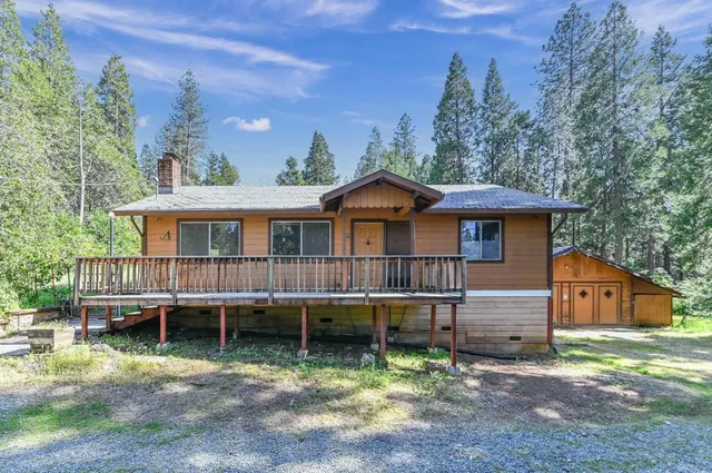 a view of a house with a yard and potted plants