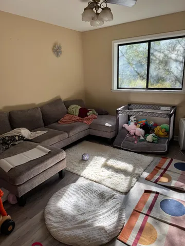 a living room with furniture and a floor to ceiling window