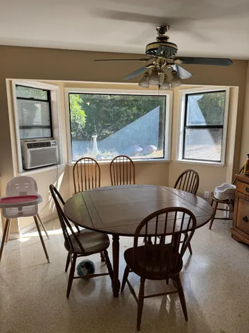 a view of a dining room with furniture window and outside view