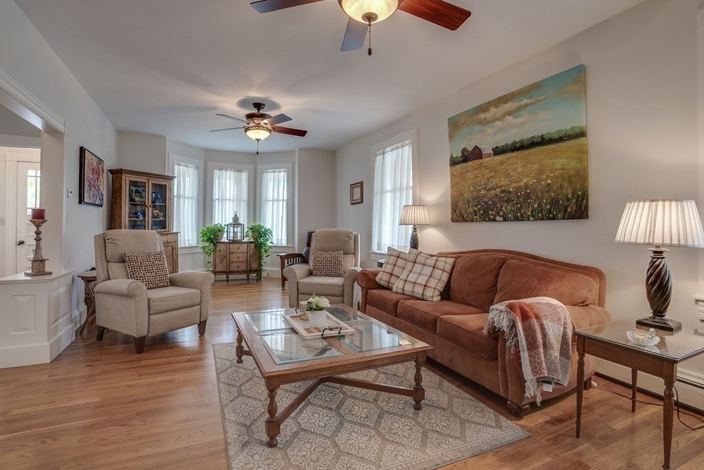 349 Boston Road Billerica, MA 01821 - Photo 11 of 41 a living room with furniture a ceiling fan a lamp and a window