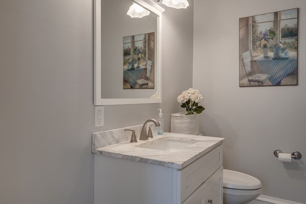 349 Boston Road Billerica, MA 01821 - Photo 14 of 41 a bathroom with a toilet a sink and mirror