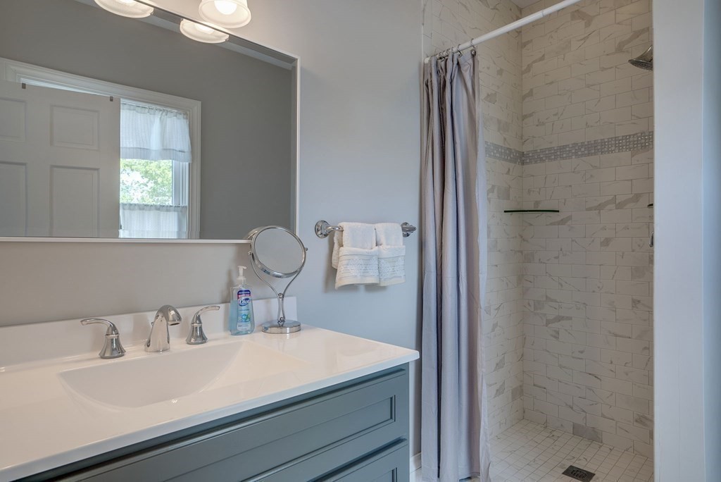 349 Boston Road Billerica, MA 01821 - Photo 22 of 41 a bathroom with a sink and a mirror