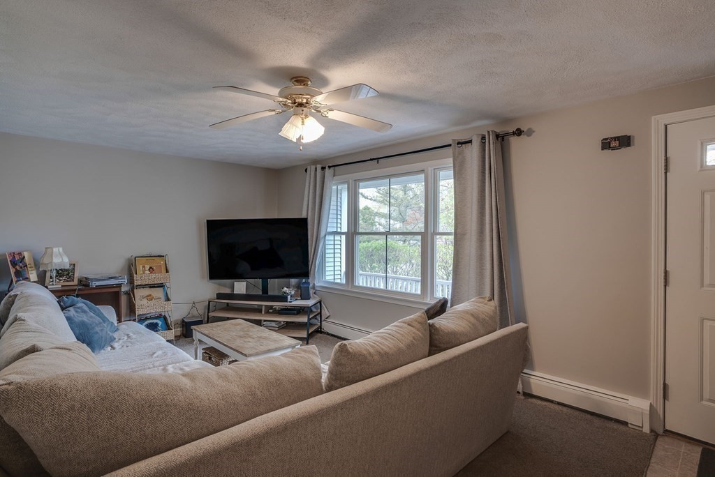 349 Boston Road Billerica, MA 01821 - Photo 25 of 41 a living room with furniture and a flat screen tv