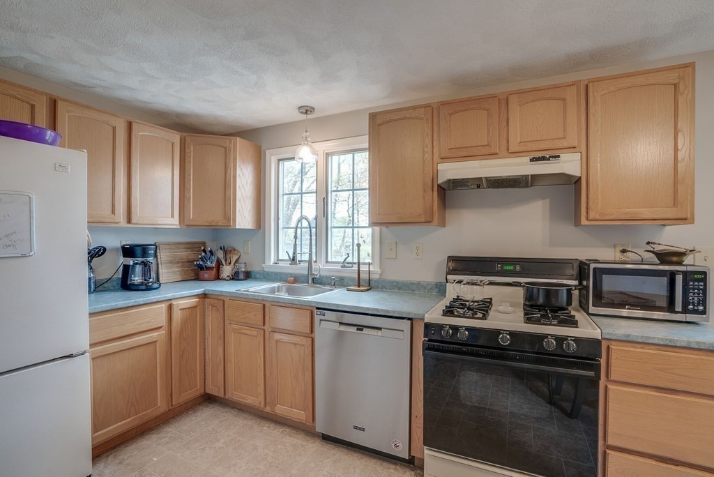 349 Boston Road Billerica, MA 01821 - Photo 27 of 41 a kitchen with cabinets appliances a sink and a window