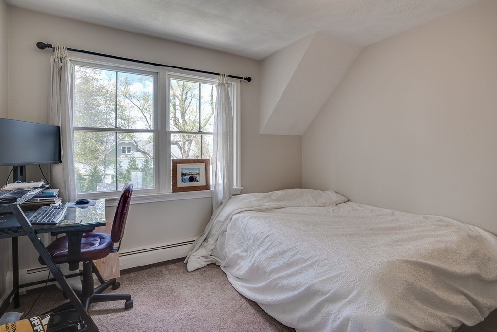 349 Boston Road Billerica, MA 01821 - Photo 30 of 41 a bed sitting in a bedroom next to a window