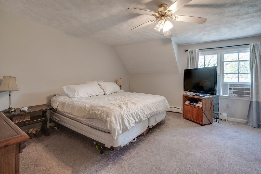 349 Boston Road Billerica, MA 01821 - Photo 31 of 41 a bedroom with a bed and a flat screen tv