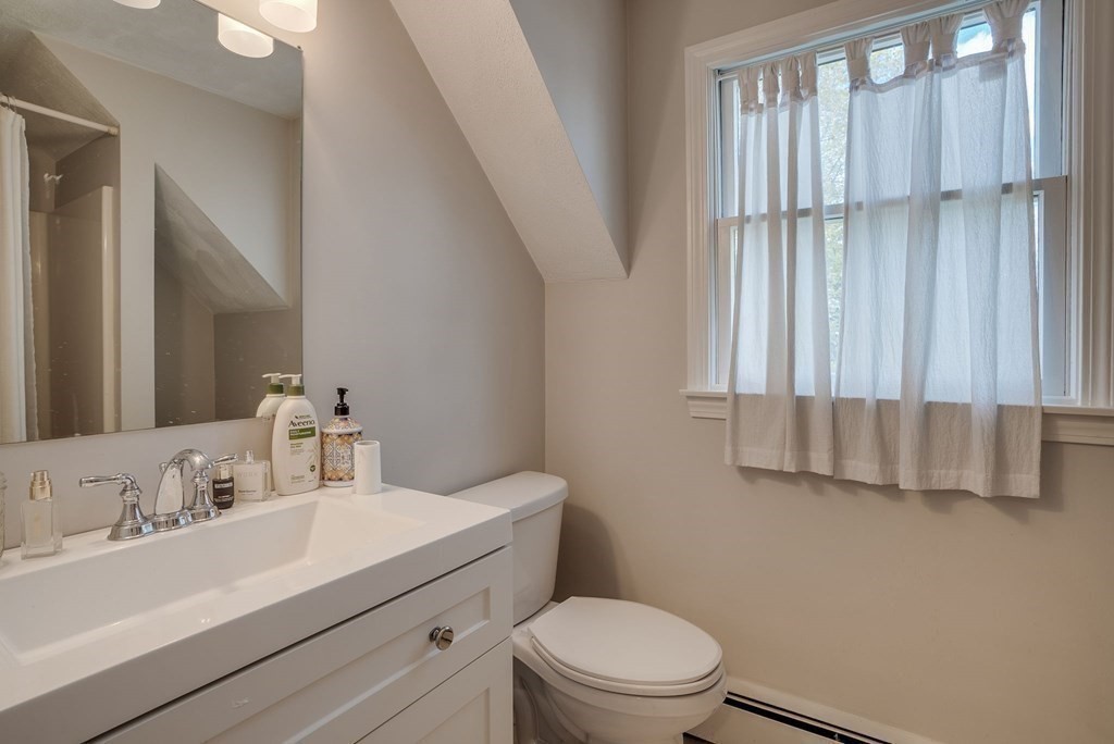 349 Boston Road Billerica, MA 01821 - Photo 32 of 41 a bathroom with a sink a toilet and shower curtain