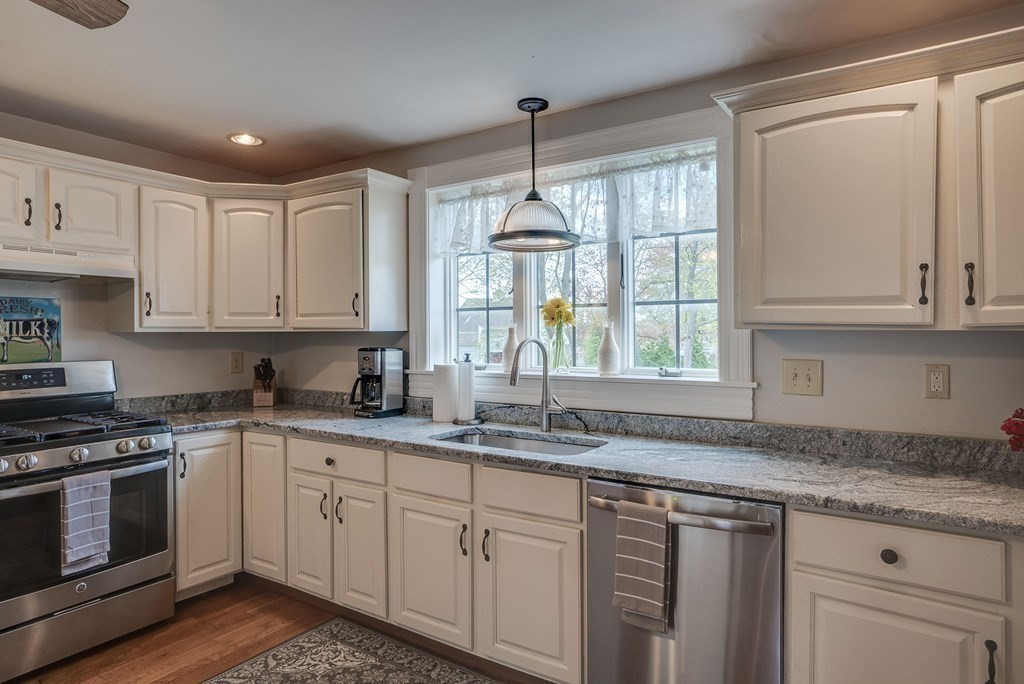 349 Boston Road Billerica, MA 01821 - Photo 5 of 41 a kitchen with granite countertop white cabinets and a window