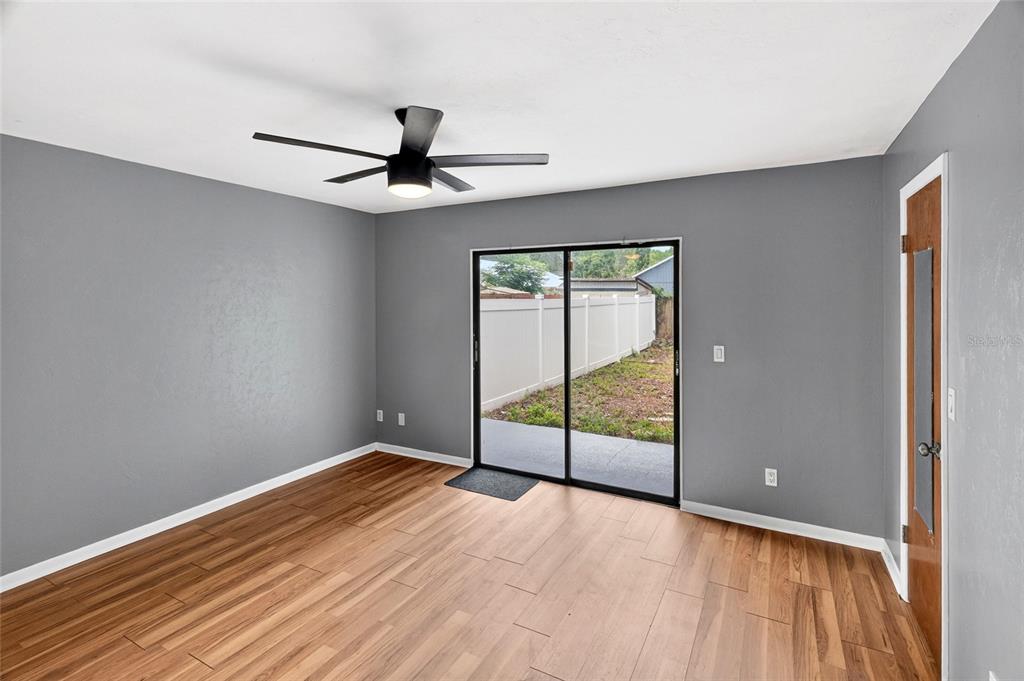 2941 Southwest 39th Avenue Gainesville, FL 32608 - Photo 13 of 39 wooden floor in an empty room with a window