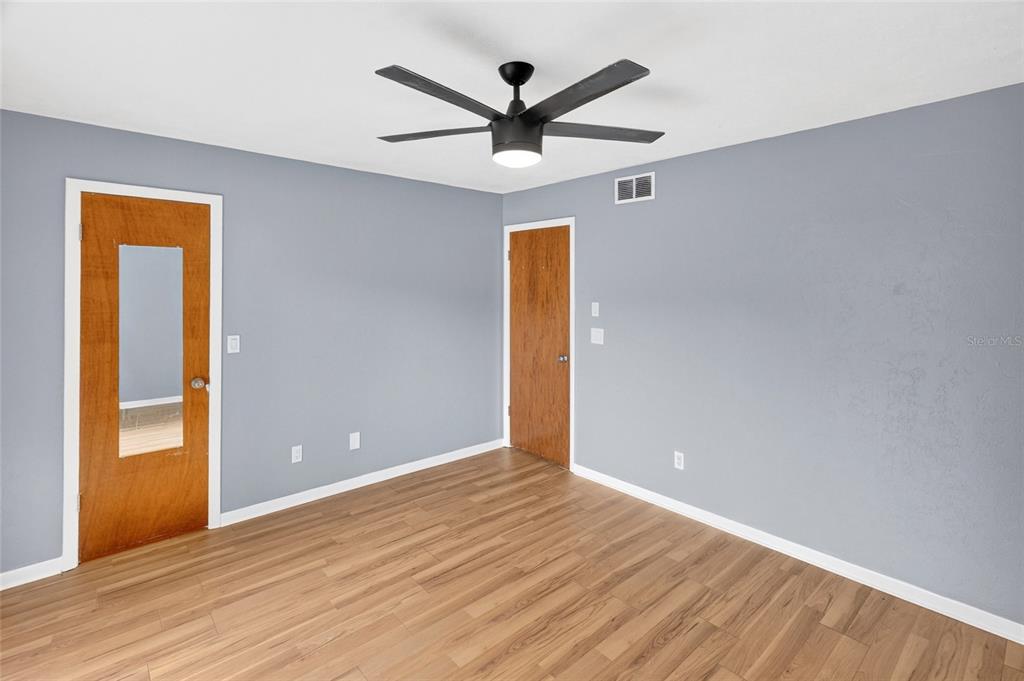 2941 Southwest 39th Avenue Gainesville, FL 32608 - Photo 16 of 39 wooden floor in an empty room with a window