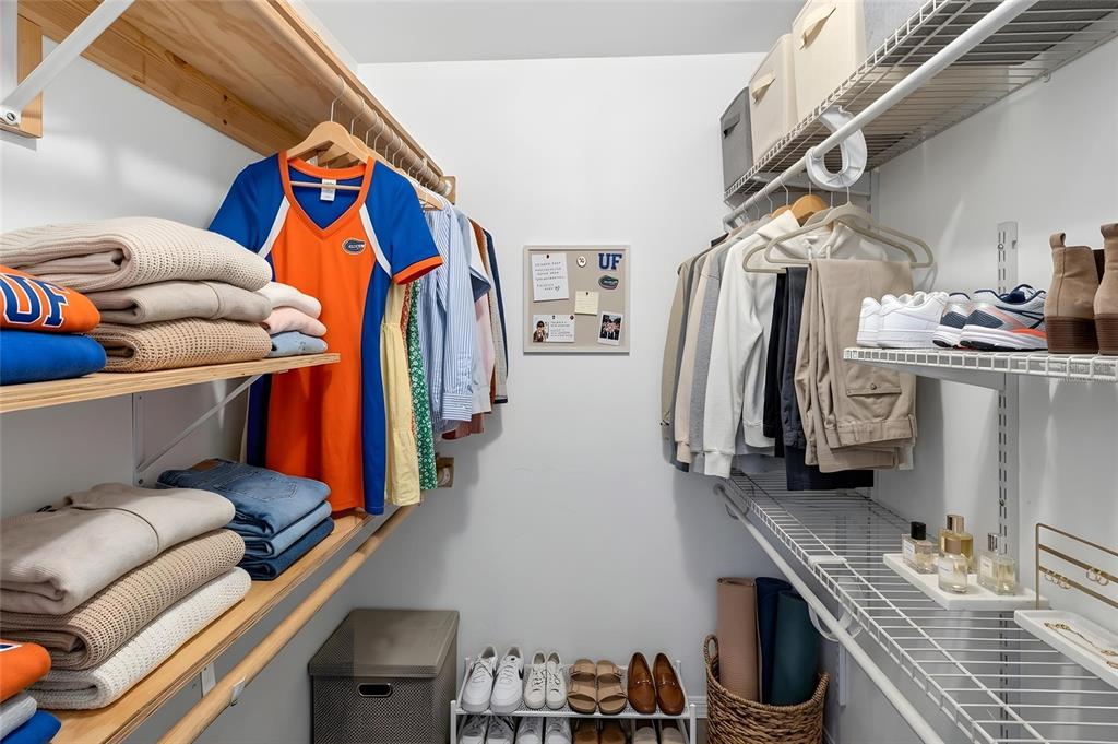 2941 Southwest 39th Avenue Gainesville, FL 32608 - Photo 18 of 39 a view of walk in closet with clothes and shoes