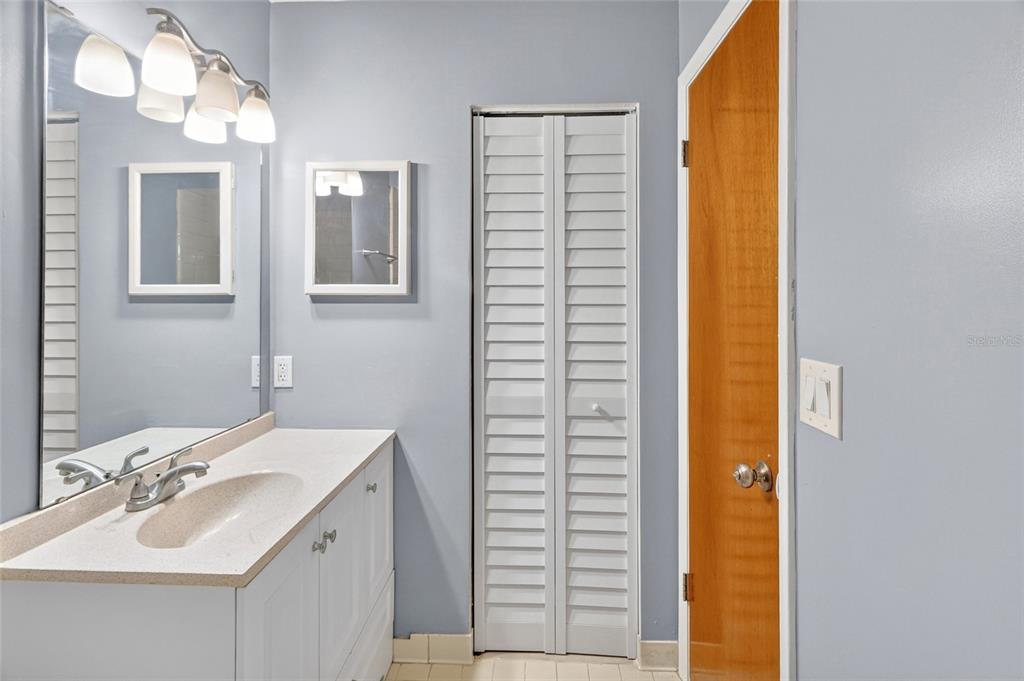 2941 Southwest 39th Avenue Gainesville, FL 32608 - Photo 20 of 39 a bathroom with a sink a mirror and a shower