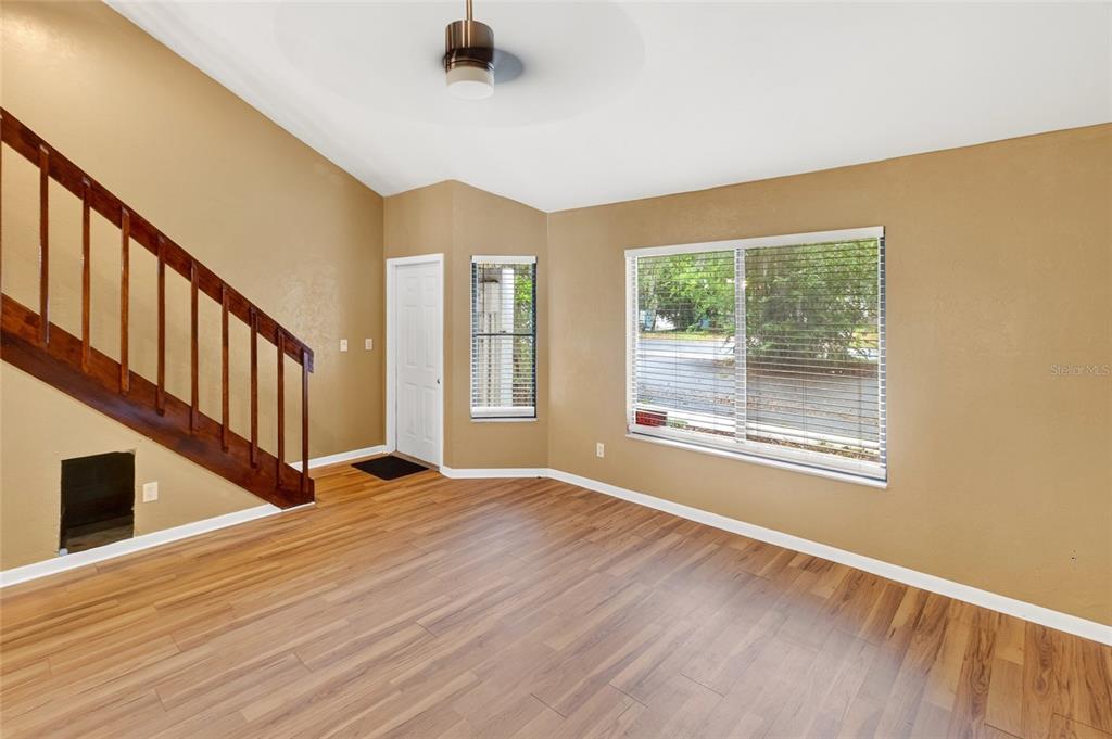 2941 Southwest 39th Avenue Gainesville, FL 32608 - Photo 2 of 39 a view of an empty room with wooden floor and windows