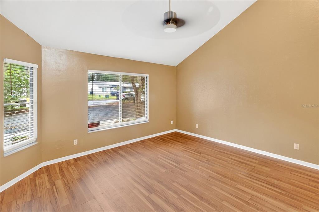 2941 Southwest 39th Avenue Gainesville, FL 32608 - Photo 3 of 39 a view of an empty room with wooden floor and a window