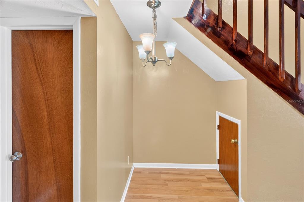 2941 Southwest 39th Avenue Gainesville, FL 32608 - Photo 7 of 39 a view of a hallway with wooden floor and staircase