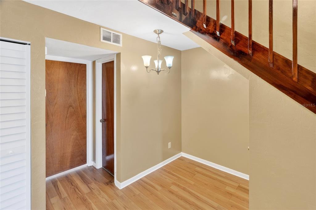 2941 Southwest 39th Avenue Gainesville, FL 32608 - Photo 9 of 39 a view of a hallway with wooden floor and staircase