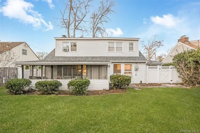 a front view of a house with a garden and plants